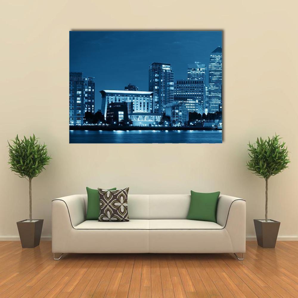 Canary Wharf London Night Skyline Canvas Wall Art in blue and navy, single panel hung on a wall