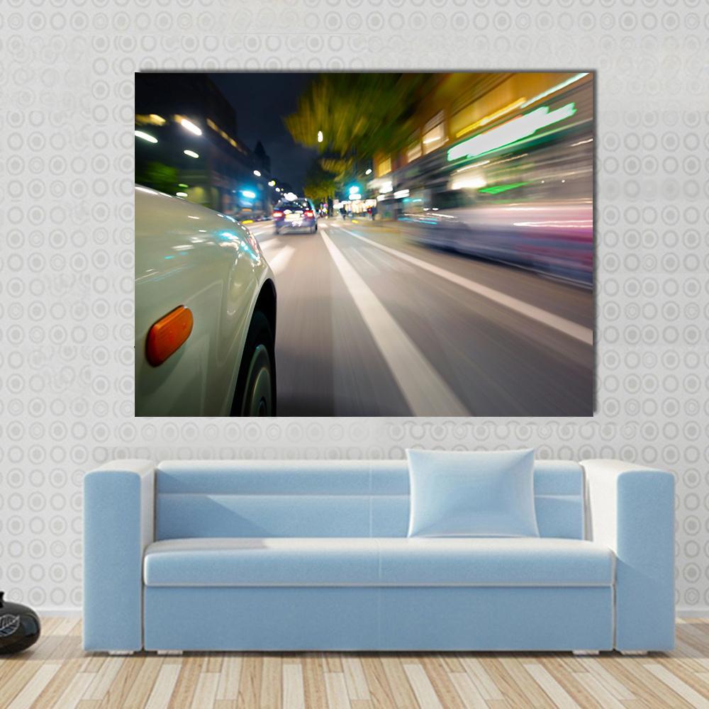 Car in Motion Blur Canvas Wall Art in black, gray and yellow, single panel hung on a wall