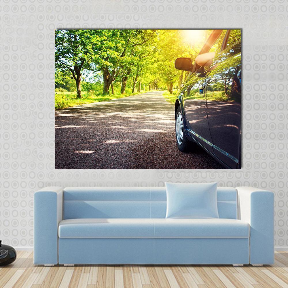 Car on Asphalt Road Canvas Wall Art in black, yellow and green, single panel hung on a wall