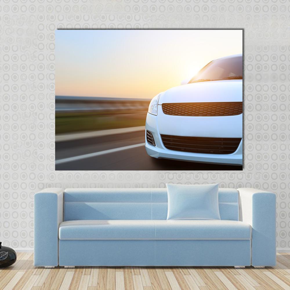 Car Speeding at Sunset Canvas Wall Art in white, orange and yellow, single panel hung on a wall
