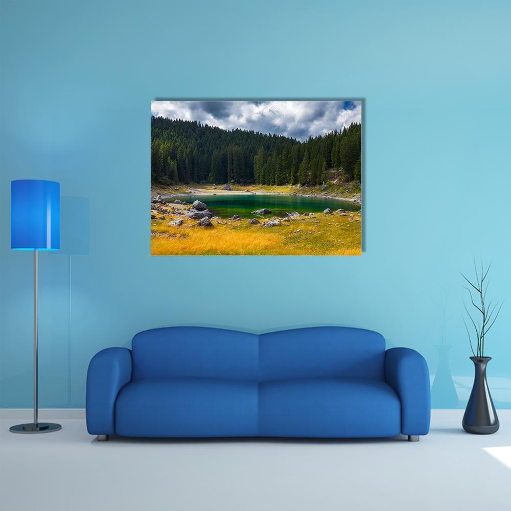 Carezza Alpine Lake Canvas Wall Art in yellow, green and blue, single panel hung on a wall