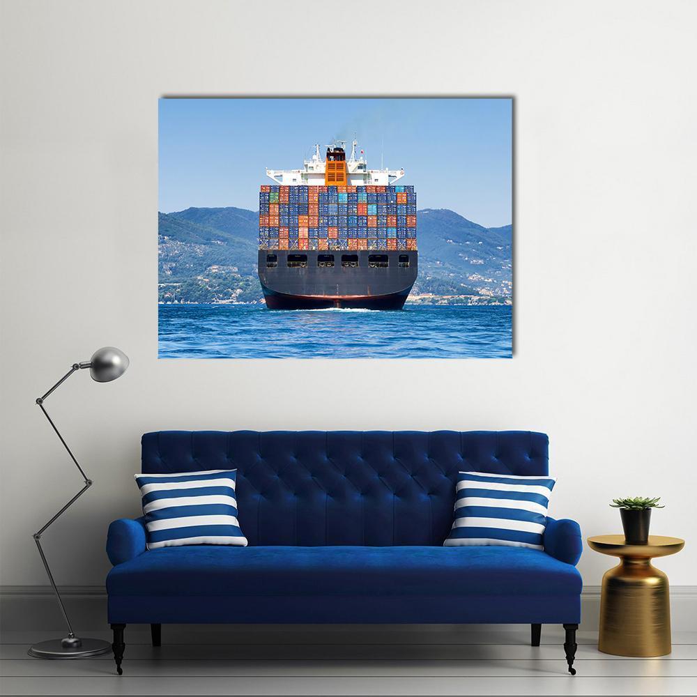 Cargo Container Ship at Sea Canvas Wall Art in blue and multicolor, single panel hung on a wall