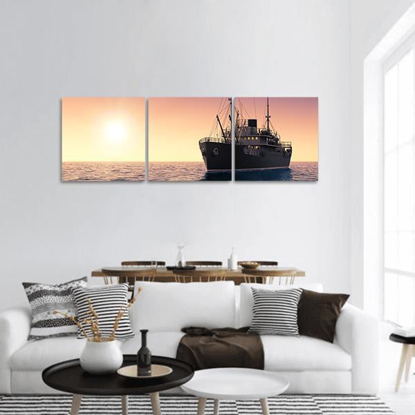 Cargo Ship at Sunset Panoramic Canvas Wall Art in black, orange and yellow, hung on a wall