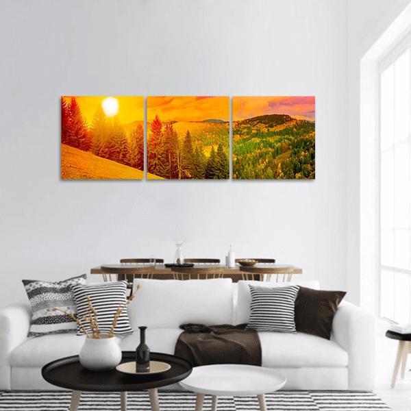 Sunlit Mountain Range at Golden Hour Panoramic Canvas Wall Art in orange, yellow and green, hung on a wall