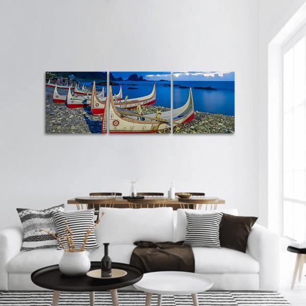 Orchid Island Canoes at Dusk Panoramic Canvas Wall Art in white, red and blue, hung on a wall