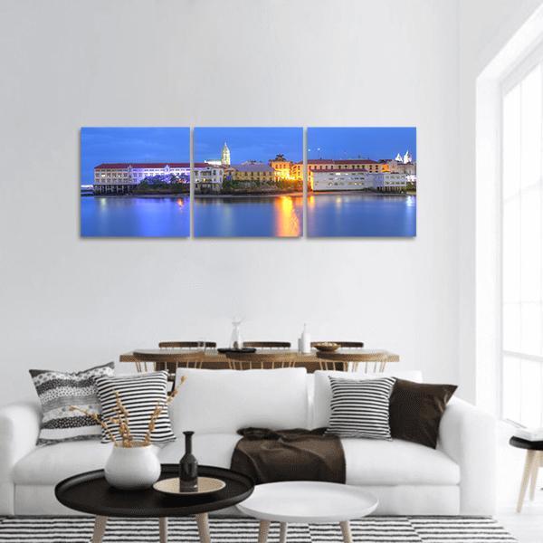 Casco Viejo at Twilight Panoramic Canvas Wall Art in orange, yellow and blue, hung on a wall