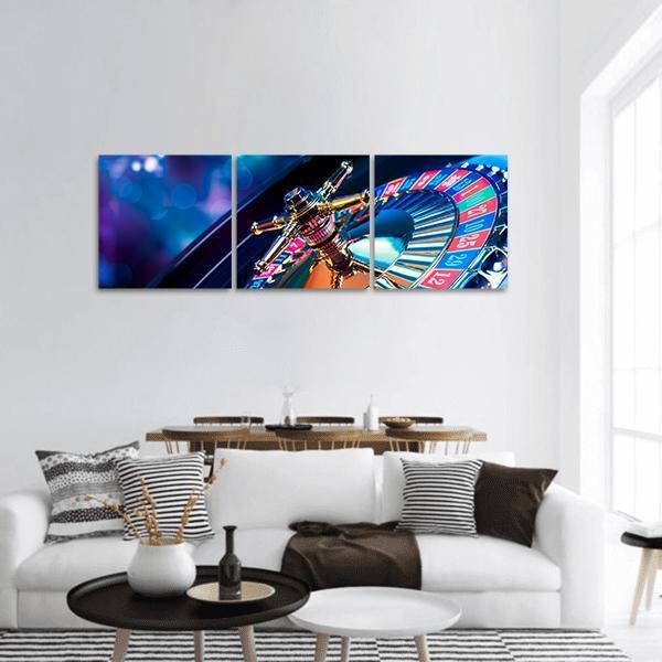 Roulette Wheel Close-up with Gold Spindle Panoramic Canvas Wall Art in black, gold and blue, hung on a wall