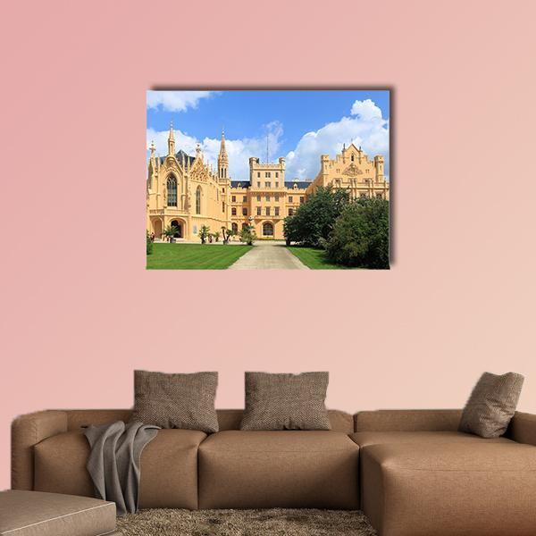 Gothic Castle with Manicured Lawn Canvas Wall Art in beige, green and blue, single panel hung on a wall