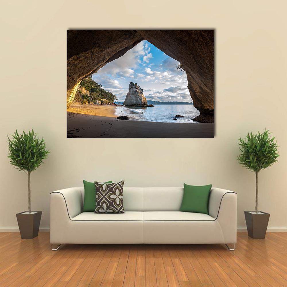 Cathedral Cove at Sunrise Canvas Wall Art in beige, brown and blue, single panel hung on a wall