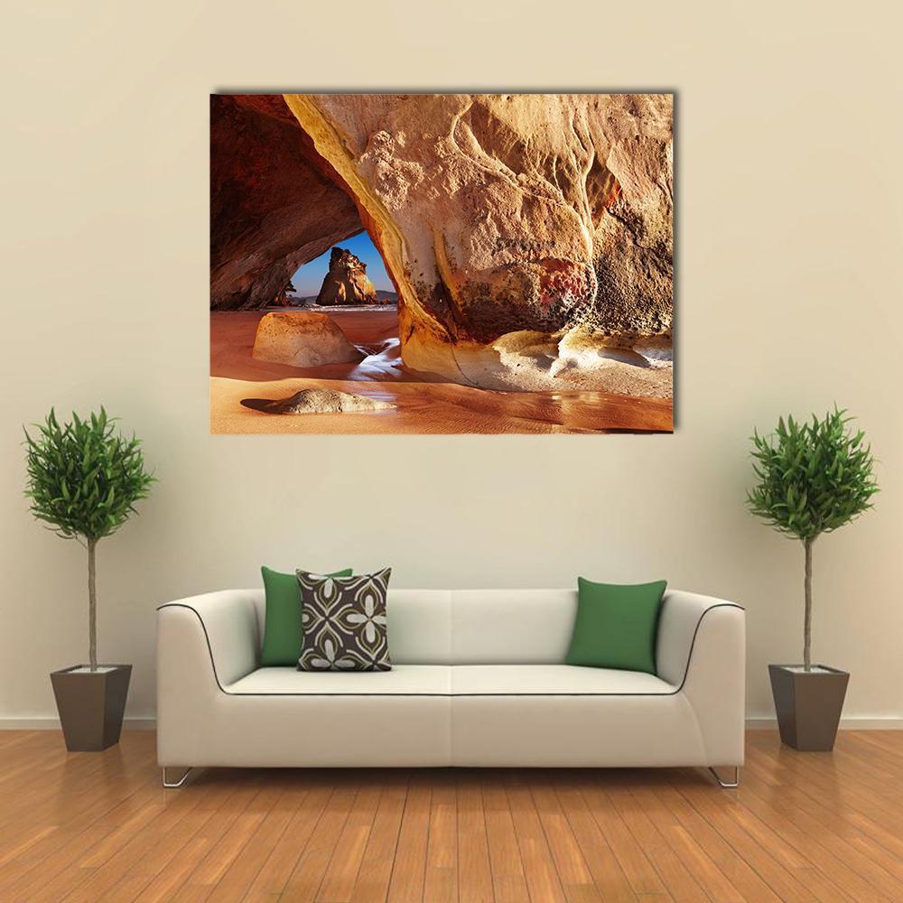 Serene Cathedral Cave in New Zealand Canvas Wall Art in beige, brown and orange, single panel hung on a wall