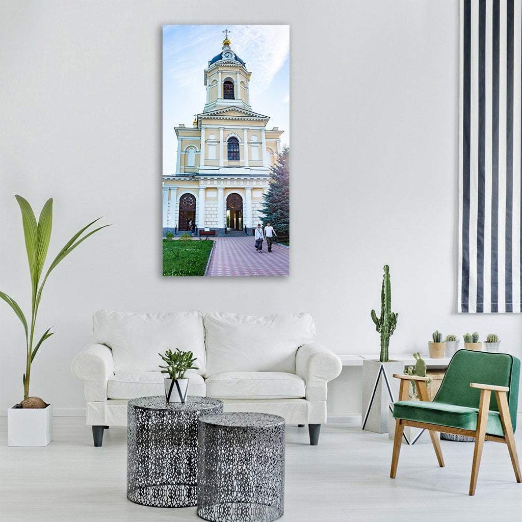 Sunlit Cathedral Monastery Vertical Canvas Wall Art in white, beige and blue, single vertical panel hung on a wall