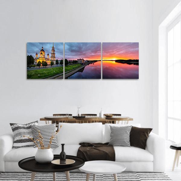Savior Transfiguration Cathedral at Sunset Panoramic Canvas Wall Art in orange, blue and purple, hung on a wall