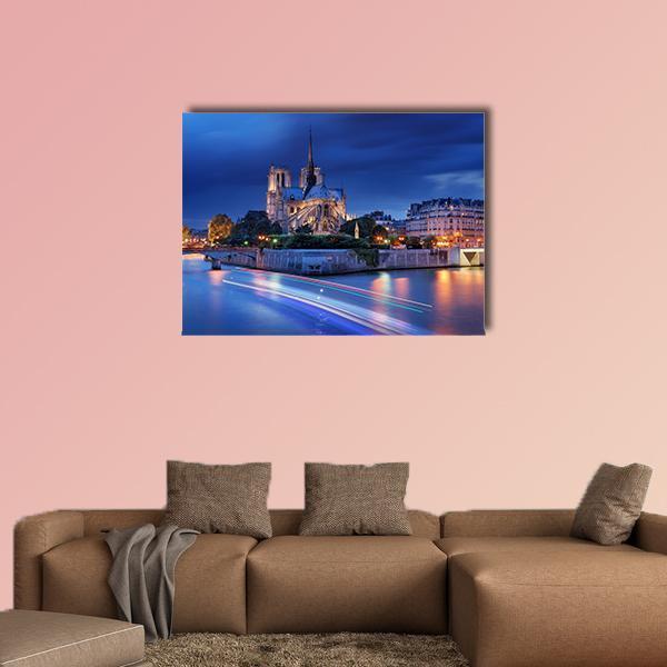 Notre Dame Cathedral at Night Canvas Wall Art in gold, blue and navy, single panel hung on a wall