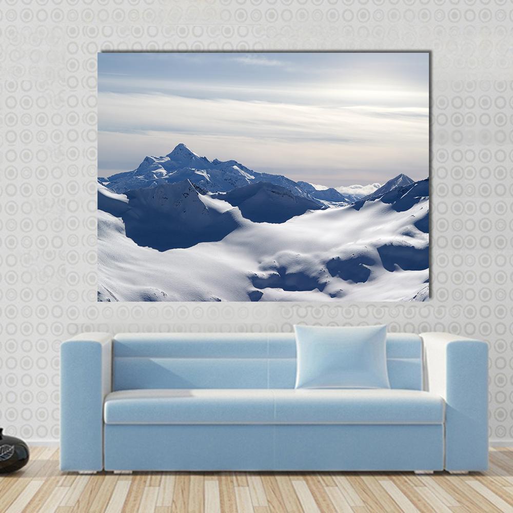 Caucasus Mountains Canvas Wall Art in white, gray and blue, single panel hung on a wall