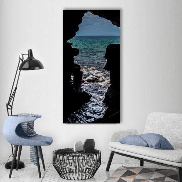 Hercules Cave, Morocco Vertical Canvas Wall Art in black, gray and blue, single vertical panel hung on a wall
