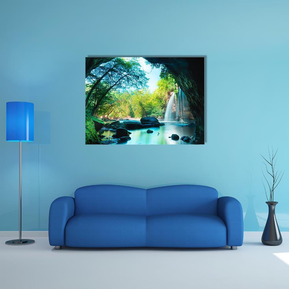 Waterfall Inside Lush Cave Canvas Wall Art in black, green and blue, single panel hung on a wall