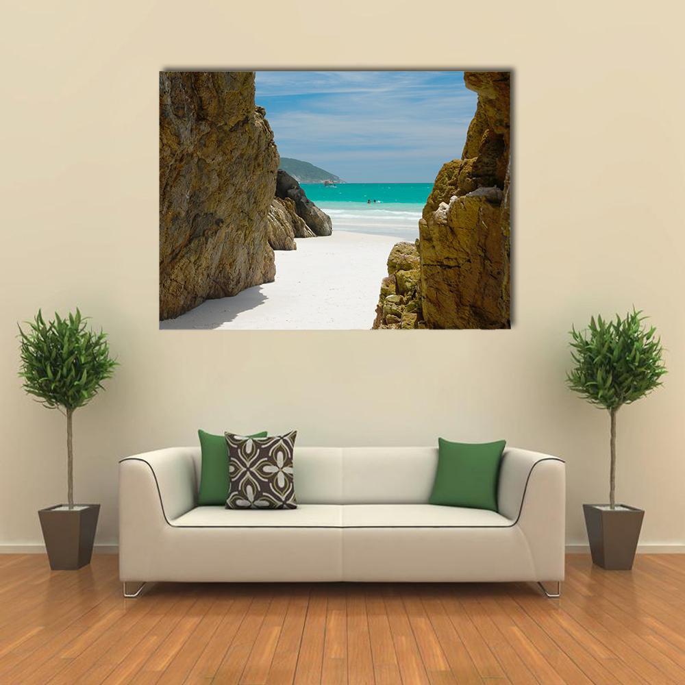 Coastal Cave with White Sand Beach Canvas Wall Art in white, brown and blue, single panel hung on a wall
