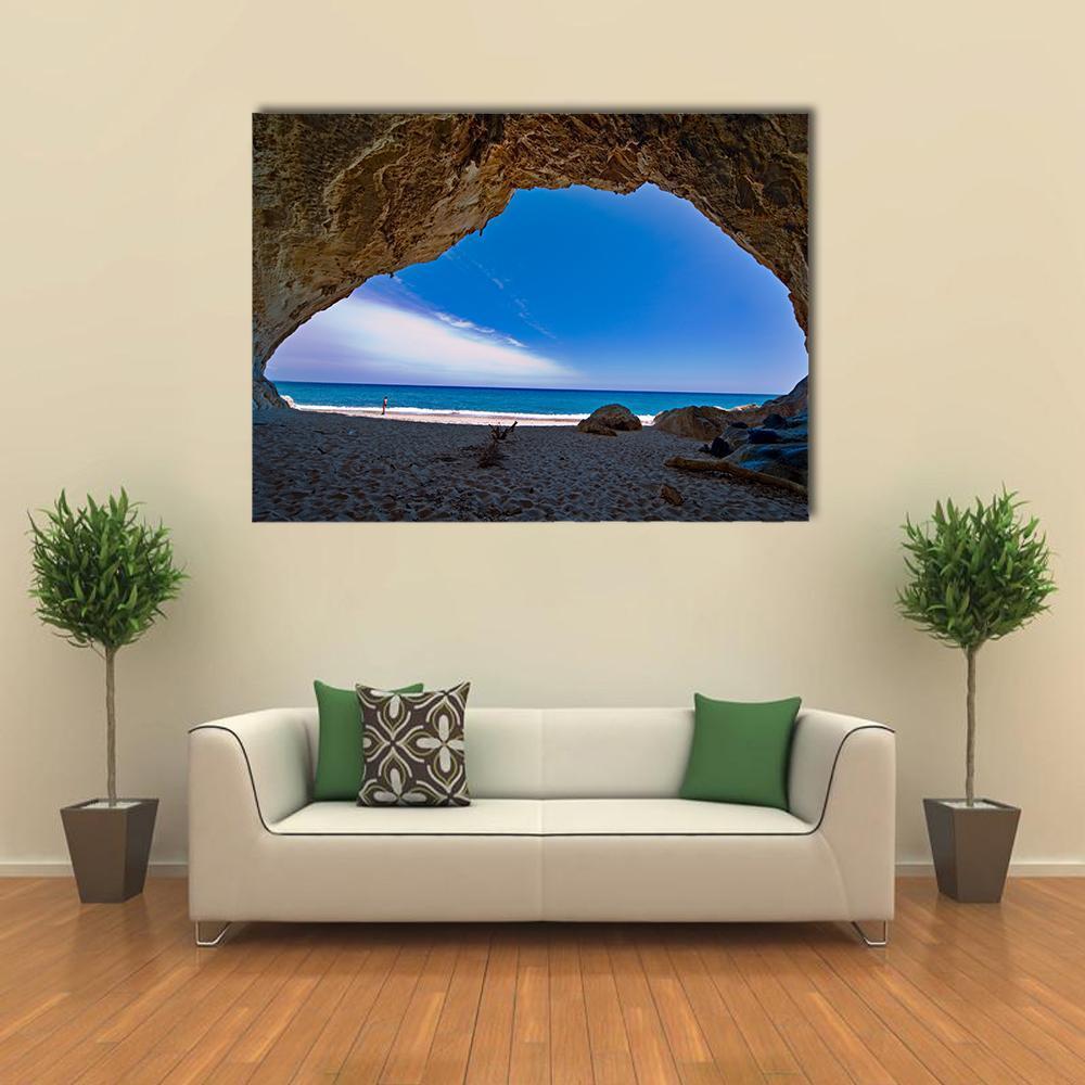 Cave and Sea Landscape Canvas Wall Art in beige, brown and blue, single panel hung on a wall
