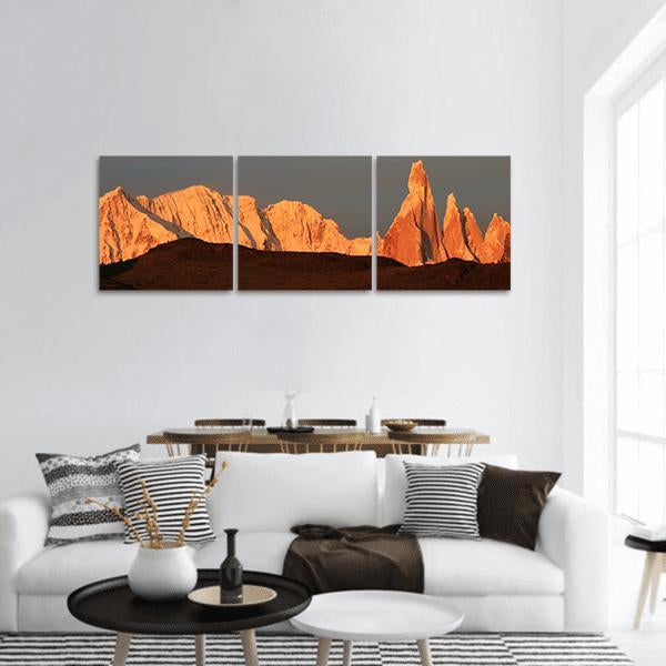 Cerro Torre at Sunrise Panoramic Canvas Wall Art in gray, brown and orange, hung on a wall
