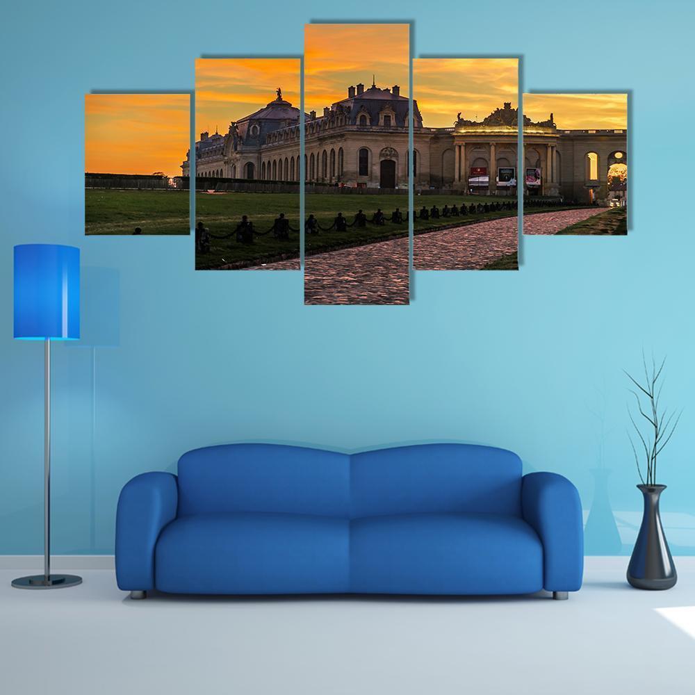 Chantilly Castle at Sunset Canvas Wall Art in orange, yellow and blue, 5 panel Star layout hung on a wall