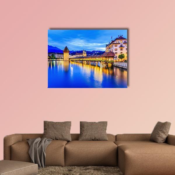 Chapel Bridge at Blue Hour Canvas Wall Art in orange, yellow and blue, single panel hung on a wall