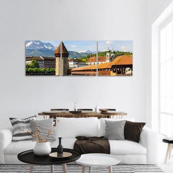 Chapel Bridge and Reuss River Panoramic Canvas Wall Art in white, brown and blue, hung on a wall