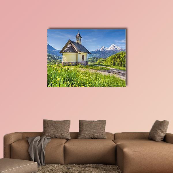 Chapel in Berchtesgaden Canvas Wall Art in yellow, green and blue, single panel hung on a wall