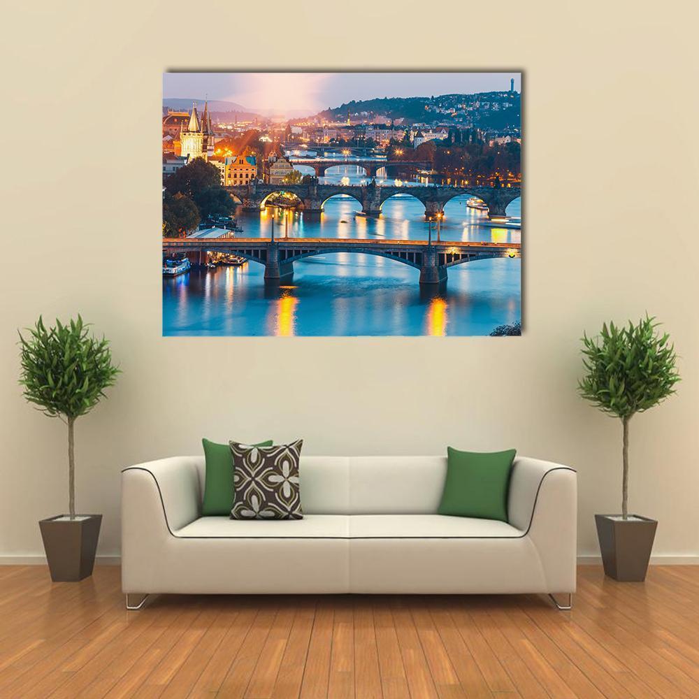 Charles Bridge and Vltava River at Dusk Canvas Wall Art in orange, yellow and blue, single panel hung on a wall