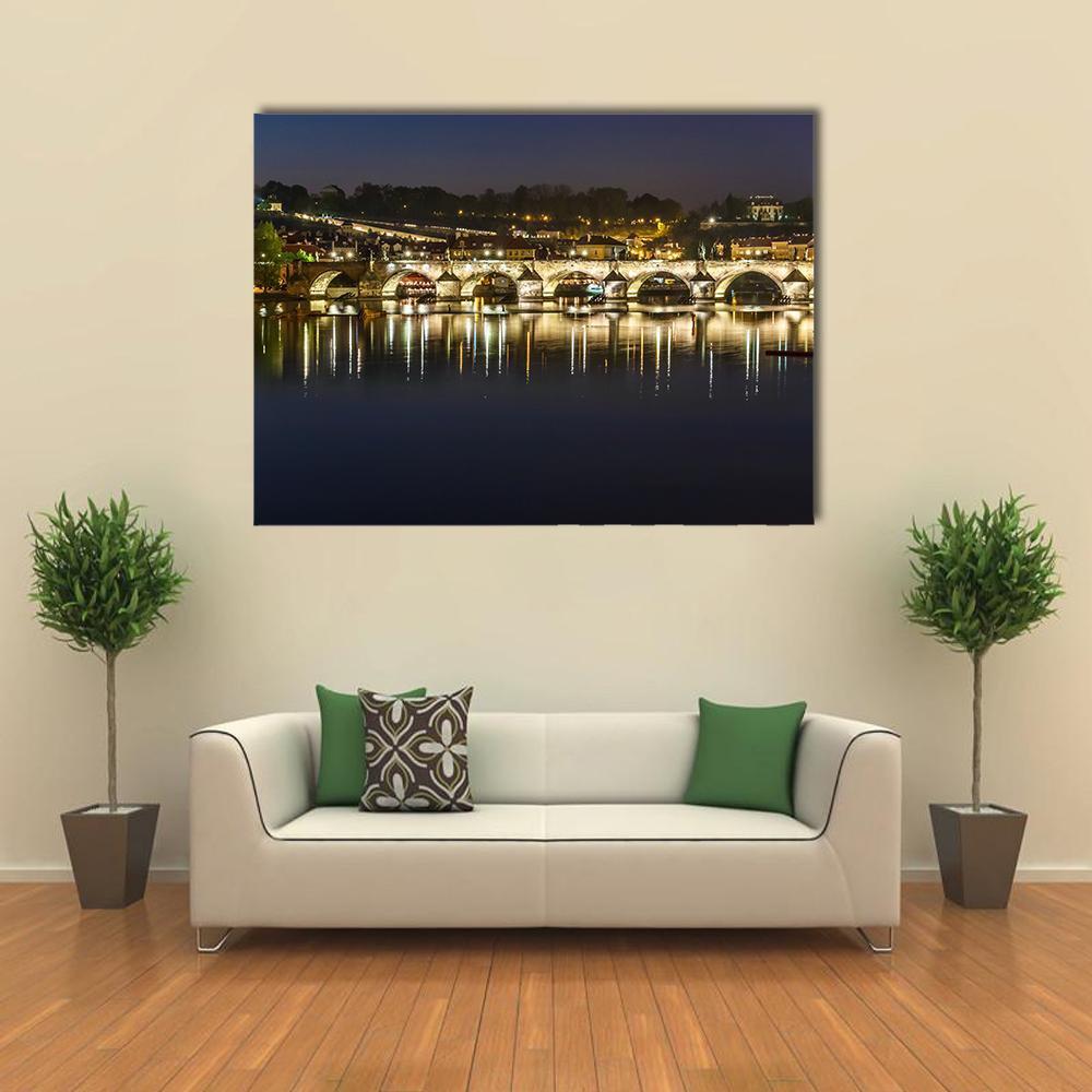 Charles Bridge at Night Canvas Wall Art in black, yellow and blue, single panel hung on a wall