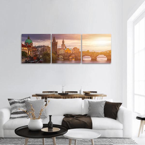 Charles Bridge in Prague at Golden Hour Panoramic Canvas Wall Art in gold, orange and purple, hung on a wall