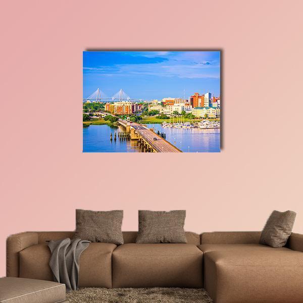 Charleston Skyline and Ashley River Canvas Wall Art in orange, yellow and blue, single panel hung on a wall