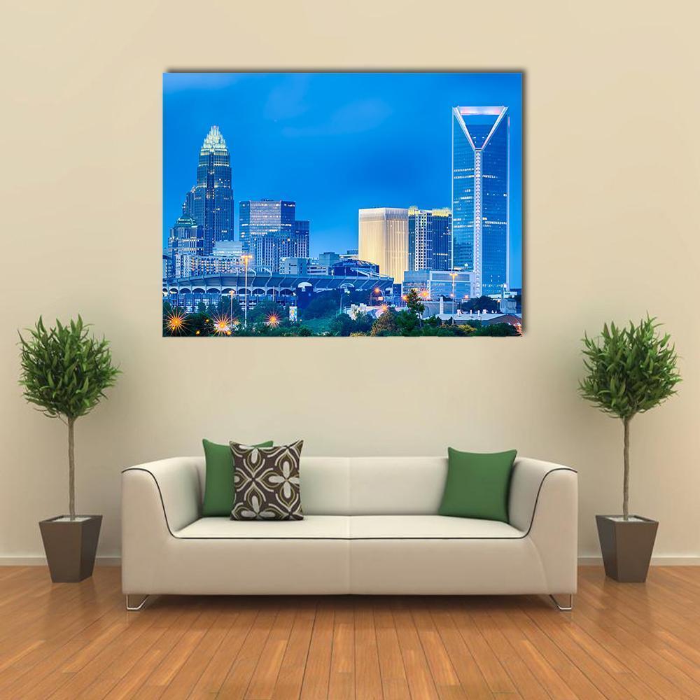 Charlotte Financial District at Night Canvas Wall Art in white, yellow and blue, single panel hung on a wall