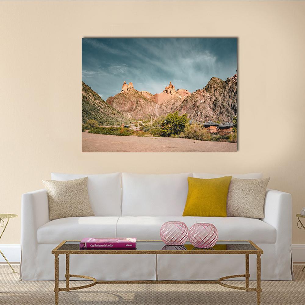 Charyn Canyon Rock Formations Canvas Wall Art in brown, orange and blue, single panel hung on a wall