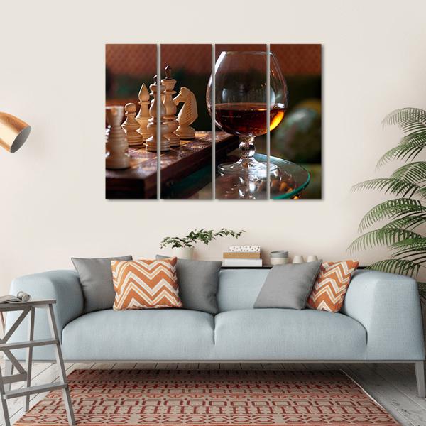 Wooden Chess Pieces and Cognac Glass Canvas Wall Art in black, beige and brown, single panel hung on a wall