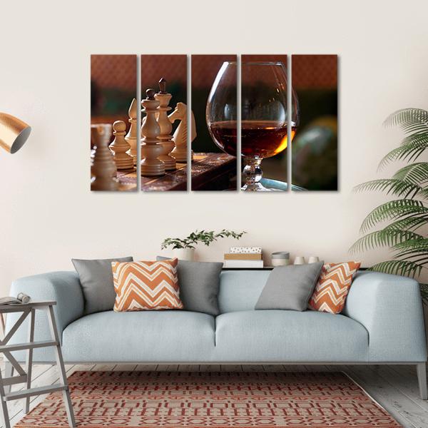 Wooden Chess Pieces and Cognac Glass Canvas Wall Art in black, beige and brown, single panel hung on a wall