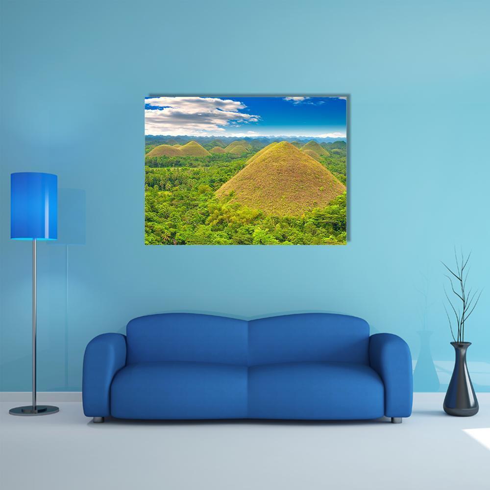Chocolate Hills Landscape Photo Canvas Wall Art in brown, green and blue, single panel hung on a wall