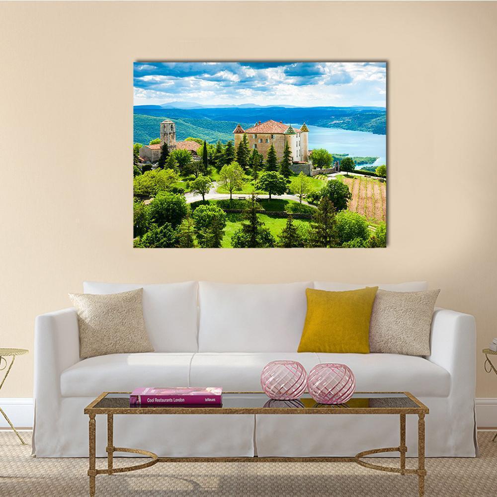 Church Tower Over Lake and Rolling Hills Canvas Wall Art in green and blue, single panel hung on a wall