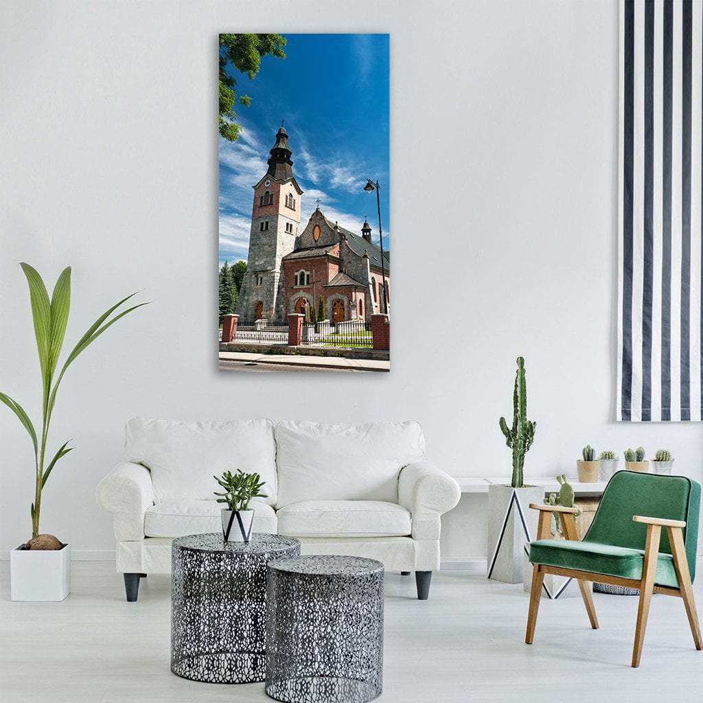 Red Brick Church Clock Tower Vertical Canvas Wall Art in brown, red and blue, single vertical panel hung on a wall