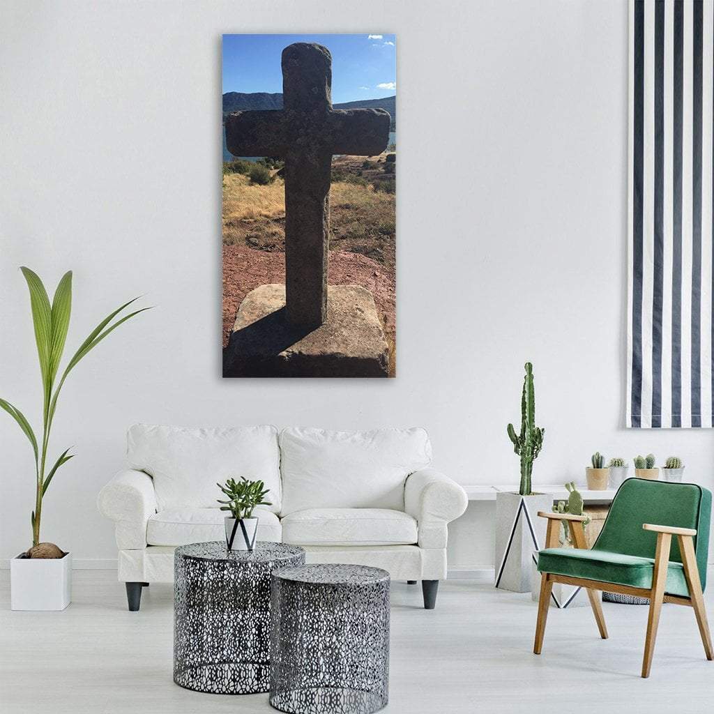 Weathered Stone Cross on Rolling Hills Vertical Canvas Wall Art in gray, brown and blue, single vertical panel hung on a wall