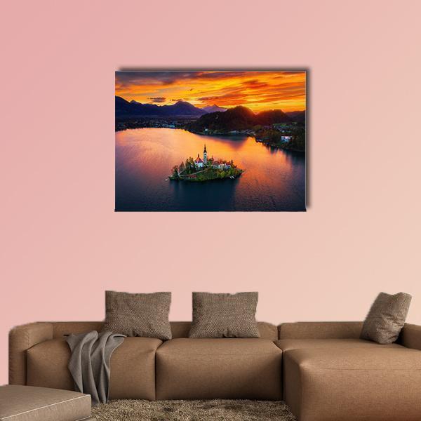 Island Church at Sunset Canvas Wall Art in orange, yellow and blue, single panel hung on a wall