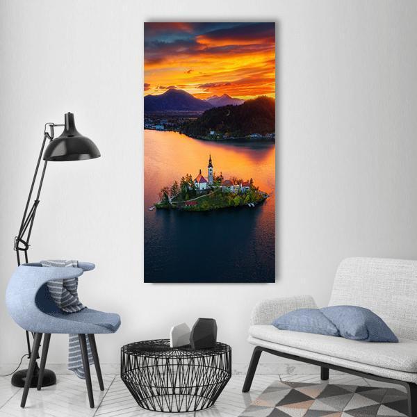 Church of Assumption on Lake Island Vertical Canvas Wall Art in orange, yellow and blue, single vertical panel hung on a wall