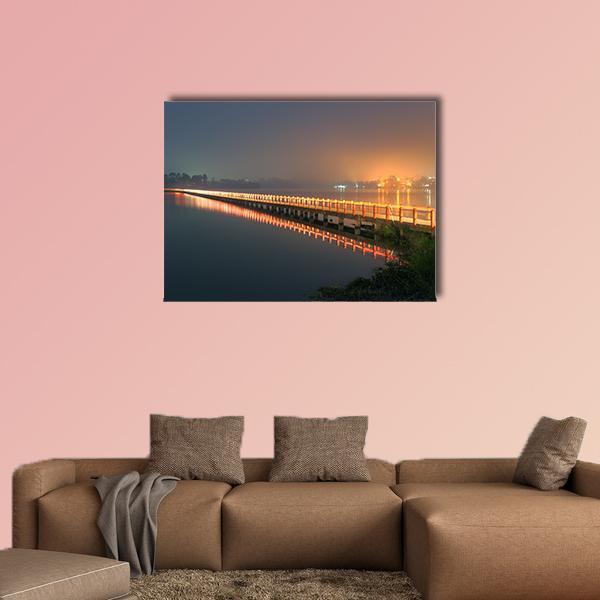Cileunca Lake Bridge at Night Canvas Wall Art in black, orange and blue, single panel hung on a wall