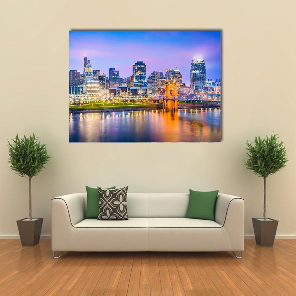 Cincinnati Skyline on River Canvas Wall Art in yellow, blue and purple, single panel hung on a wall