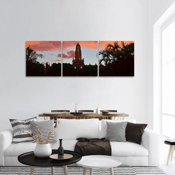 City Hall Clock Tower at Dusk Panoramic Canvas Wall Art in black, orange and pink, hung on a wall