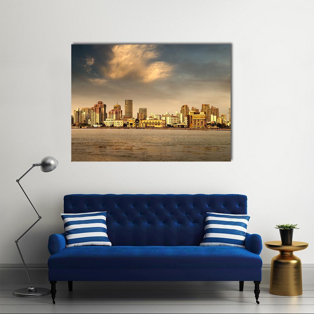 Sunset Over Waterfront City Canvas Wall Art in brown, orange and yellow, single panel hung on a wall