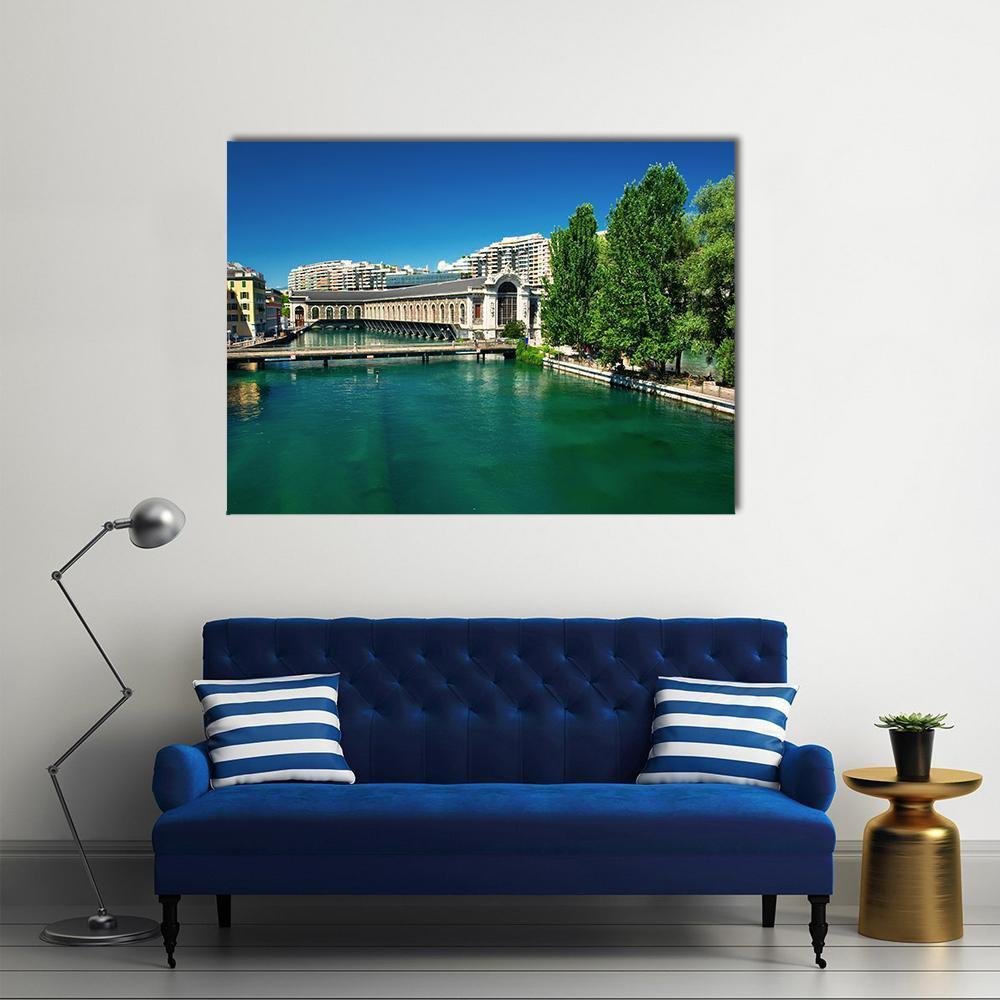 Geneva Arched Bridge Over Emerald River Canvas Wall Art in green and blue, single panel hung on a wall