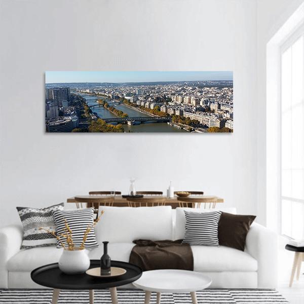 Aerial View of Paris and the Seine Panoramic Canvas Wall Art in white, gray and blue, hung on a wall
