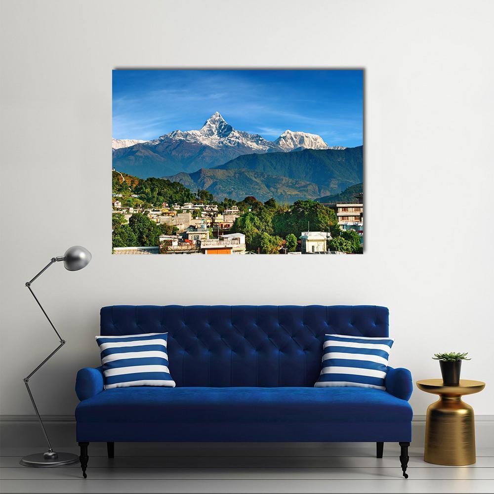 Pokhara Mountain Village Canvas Wall Art in white, green and blue, single panel hung on a wall