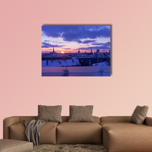 Riga Winter Sunset Skyline Canvas Wall Art in blue, purple and pink, single panel hung on a wall
