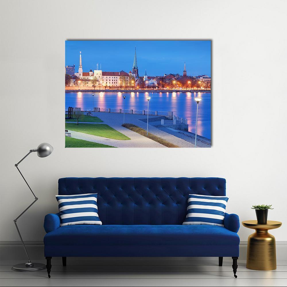 City Skyline Over the Daugava River Canvas Wall Art in yellow and blue, single panel hung on a wall